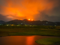 A mountain wildfire and milky way seen from a Teldeniya old town in Kandy, Sri Lanka, on July  22, 2023 (