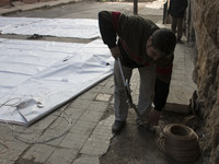 A man prepares a rope to raise the curtains  on Bustan Alqasr district in Aleppo city on 1st February 2016.
(
