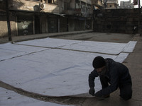 A man prepares curtains before raise it  on Bustan Alqasr district in Aleppo city on 1st February 2016.
(