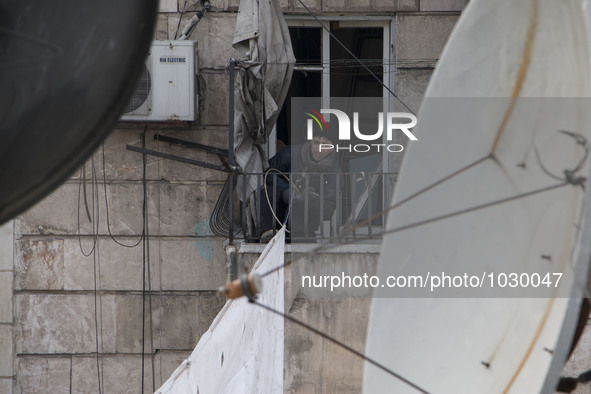 A man tied ropes curtains  on Bustan Alqasr district in Aleppo city on 1st February 2016.
