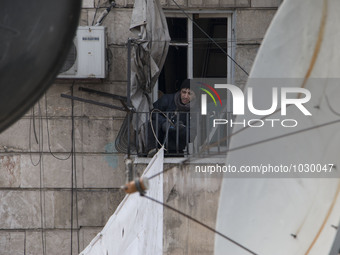 A man tied ropes curtains  on Bustan Alqasr district in Aleppo city on 1st February 2016.
(
