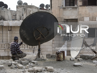 two men are tieding ropes curtains  on Bustan Alqasr district in Aleppo city on 1st February 2016.
(