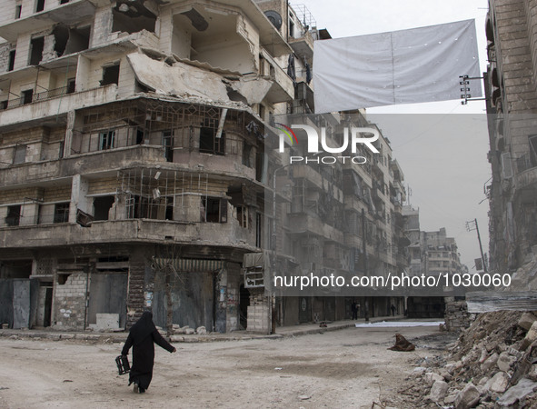 A women walking near one of curtains  on Bustan Alqasr district in Aleppo city on 1st February 2016.
