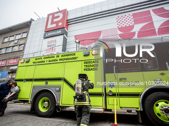 
Firefighters respond to a gas explosion emergency at a residential building in Osorno on July 26, 2023. (