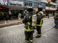 
Firefighters respond to a gas explosion emergency at a residential building in Osorno on July 26, 2023. (