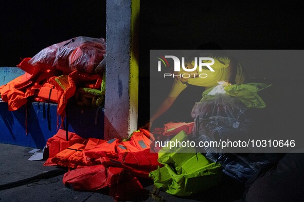 A man looks at the life vests and belongings of the passengers of the capsized boat in Laguna Lake that killed more than 20 people, in Binan...