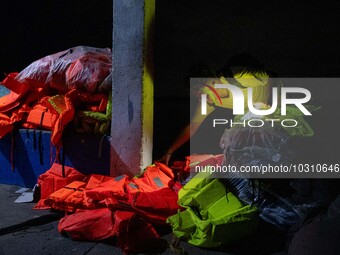 A man looks at the life vests and belongings of the passengers of the capsized boat in Laguna Lake that killed more than 20 people, in Binan...