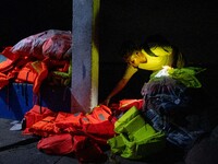 A man looks at the life vests and belongings of the passengers of the capsized boat in Laguna Lake that killed more than 20 people, in Binan...