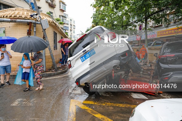 Cars blown over after Super Typhoon Doksuri torrential rain in a community in Jinan, East China's Shandong Province, July 29, 2023. 