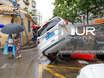 Cars blown over after Super Typhoon Doksuri torrential rain in a community in Jinan, East China's Shandong Province, July 29, 2023. (