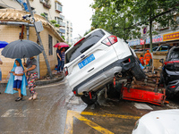 Cars blown over after Super Typhoon Doksuri torrential rain in a community in Jinan, East China's Shandong Province, July 29, 2023. (