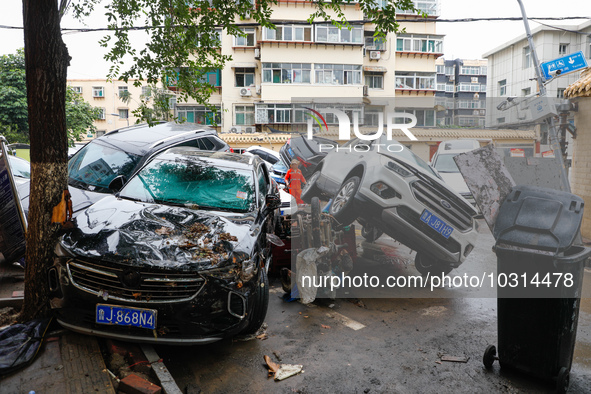 Cars blown over after Super Typhoon Doksuri torrential rain in a community in Jinan, East China's Shandong Province, July 29, 2023. 