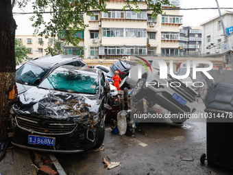 Cars blown over after Super Typhoon Doksuri torrential rain in a community in Jinan, East China's Shandong Province, July 29, 2023. (