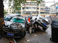 Cars blown over after Super Typhoon Doksuri torrential rain in a community in Jinan, East China's Shandong Province, July 29, 2023. (