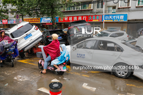 Cars blown over after Super Typhoon Doksuri torrential rain in a community in Jinan, East China's Shandong Province, July 29, 2023. 