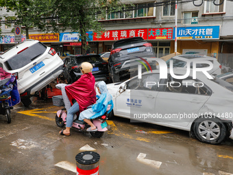 Cars blown over after Super Typhoon Doksuri torrential rain in a community in Jinan, East China's Shandong Province, July 29, 2023. (