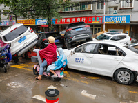 Cars blown over after Super Typhoon Doksuri torrential rain in a community in Jinan, East China's Shandong Province, July 29, 2023. (