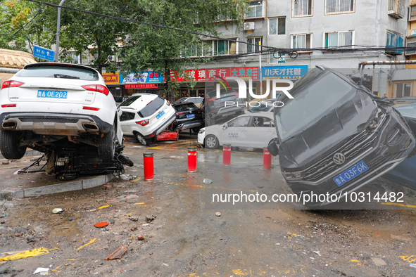 Cars blown over after Super Typhoon Doksuri torrential rain in a community in Jinan, East China's Shandong Province, July 29, 2023. 