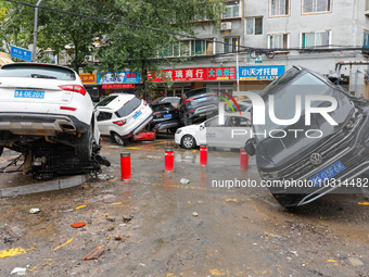 Cars blown over after Super Typhoon Doksuri torrential rain in a community in Jinan, East China's Shandong Province, July 29, 2023. (