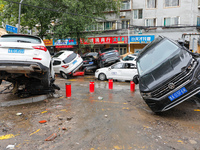 Cars blown over after Super Typhoon Doksuri torrential rain in a community in Jinan, East China's Shandong Province, July 29, 2023. (