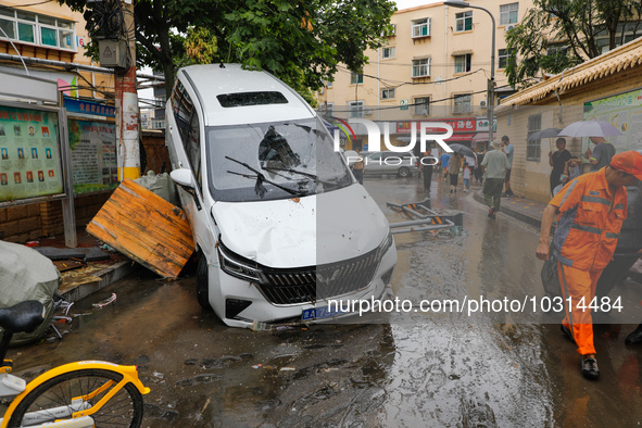 Cars blown over after Super Typhoon Doksuri torrential rain in a community in Jinan, East China's Shandong Province, July 29, 2023. 