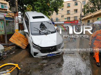 Cars blown over after Super Typhoon Doksuri torrential rain in a community in Jinan, East China's Shandong Province, July 29, 2023. (