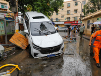 Cars blown over after Super Typhoon Doksuri torrential rain in a community in Jinan, East China's Shandong Province, July 29, 2023. (