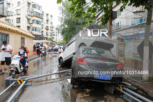 Cars blown over after Super Typhoon Doksuri torrential rain in a community in Jinan, East China's Shandong Province, July 29, 2023. 