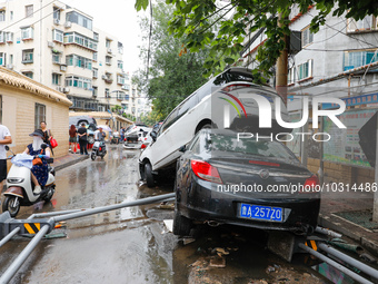 Cars blown over after Super Typhoon Doksuri torrential rain in a community in Jinan, East China's Shandong Province, July 29, 2023. (