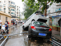 Cars blown over after Super Typhoon Doksuri torrential rain in a community in Jinan, East China's Shandong Province, July 29, 2023. (