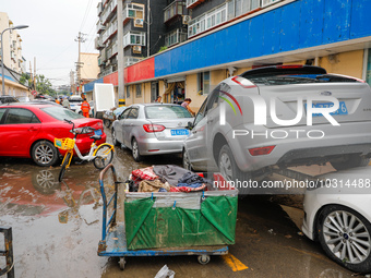 Cars blown over after Super Typhoon Doksuri torrential rain in a community in Jinan, East China's Shandong Province, July 29, 2023. (