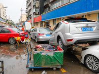 Cars blown over after Super Typhoon Doksuri torrential rain in a community in Jinan, East China's Shandong Province, July 29, 2023. (