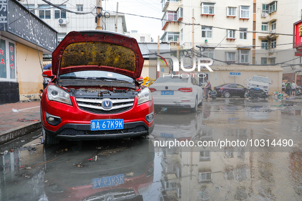 Cars blown over after Super Typhoon Doksuri torrential rain in a community in Jinan, East China's Shandong Province, July 29, 2023. 