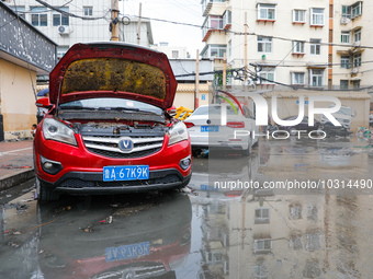 Cars blown over after Super Typhoon Doksuri torrential rain in a community in Jinan, East China's Shandong Province, July 29, 2023. (