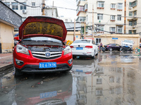 Cars blown over after Super Typhoon Doksuri torrential rain in a community in Jinan, East China's Shandong Province, July 29, 2023. (