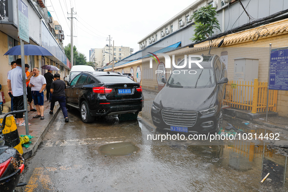 Cars blown over after Super Typhoon Doksuri torrential rain in a community in Jinan, East China's Shandong Province, July 29, 2023. 