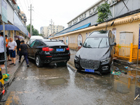 Cars blown over after Super Typhoon Doksuri torrential rain in a community in Jinan, East China's Shandong Province, July 29, 2023. (