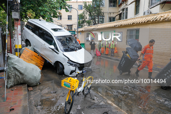 Cars blown over after Super Typhoon Doksuri torrential rain in a community in Jinan, East China's Shandong Province, July 29, 2023. 