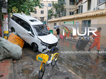 Cars blown over after Super Typhoon Doksuri torrential rain in a community in Jinan, East China's Shandong Province, July 29, 2023. (