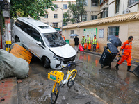 Cars blown over after Super Typhoon Doksuri torrential rain in a community in Jinan, East China's Shandong Province, July 29, 2023. (