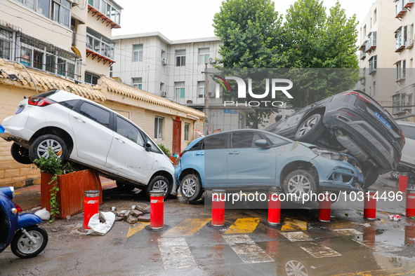 Cars blown over after Super Typhoon Doksuri torrential rain in a community in Jinan, East China's Shandong Province, July 29, 2023. 