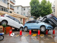 Cars blown over after Super Typhoon Doksuri torrential rain in a community in Jinan, East China's Shandong Province, July 29, 2023. (