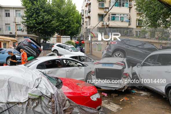 Cars blown over after Super Typhoon Doksuri torrential rain in a community in Jinan, East China's Shandong Province, July 29, 2023. 