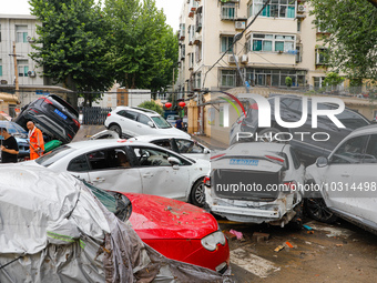 Cars blown over after Super Typhoon Doksuri torrential rain in a community in Jinan, East China's Shandong Province, July 29, 2023. (