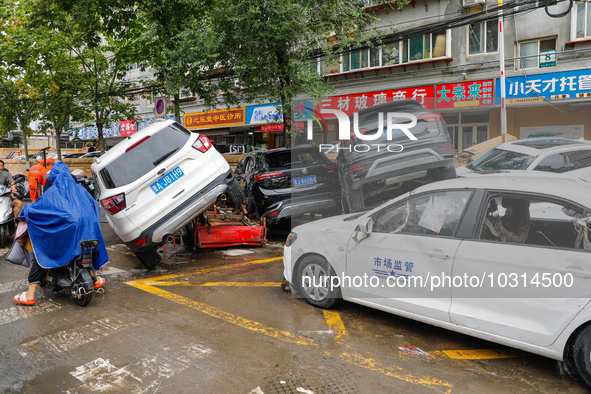 Cars blown over after Super Typhoon Doksuri torrential rain in a community in Jinan, East China's Shandong Province, July 29, 2023. 