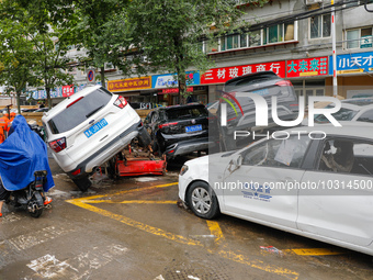 Cars blown over after Super Typhoon Doksuri torrential rain in a community in Jinan, East China's Shandong Province, July 29, 2023. (