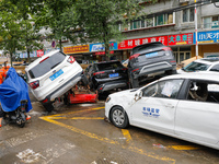 Cars blown over after Super Typhoon Doksuri torrential rain in a community in Jinan, East China's Shandong Province, July 29, 2023. (