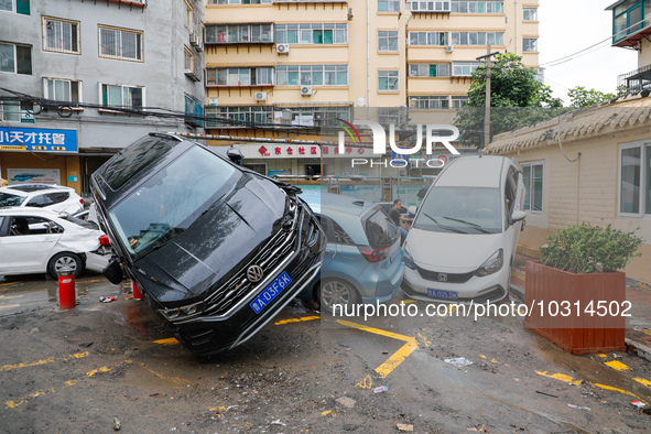 Cars blown over after Super Typhoon Doksuri torrential rain in a community in Jinan, East China's Shandong Province, July 29, 2023. 