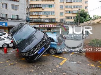 Cars blown over after Super Typhoon Doksuri torrential rain in a community in Jinan, East China's Shandong Province, July 29, 2023. (