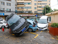 Cars blown over after Super Typhoon Doksuri torrential rain in a community in Jinan, East China's Shandong Province, July 29, 2023. (